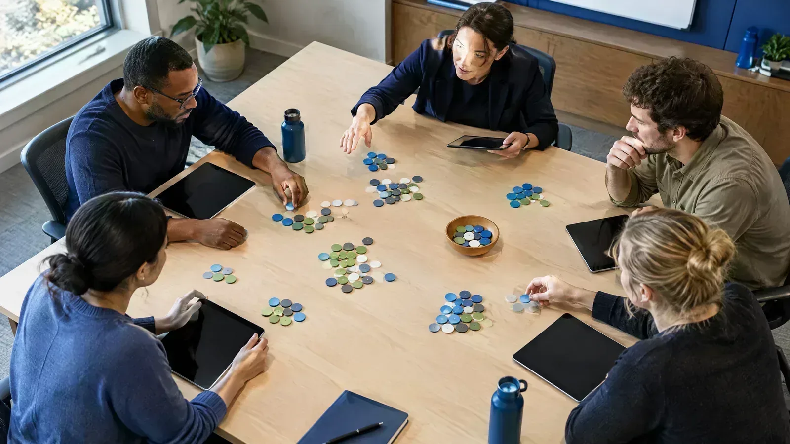 A payment-operations team organises route markers during an ownership workshop.