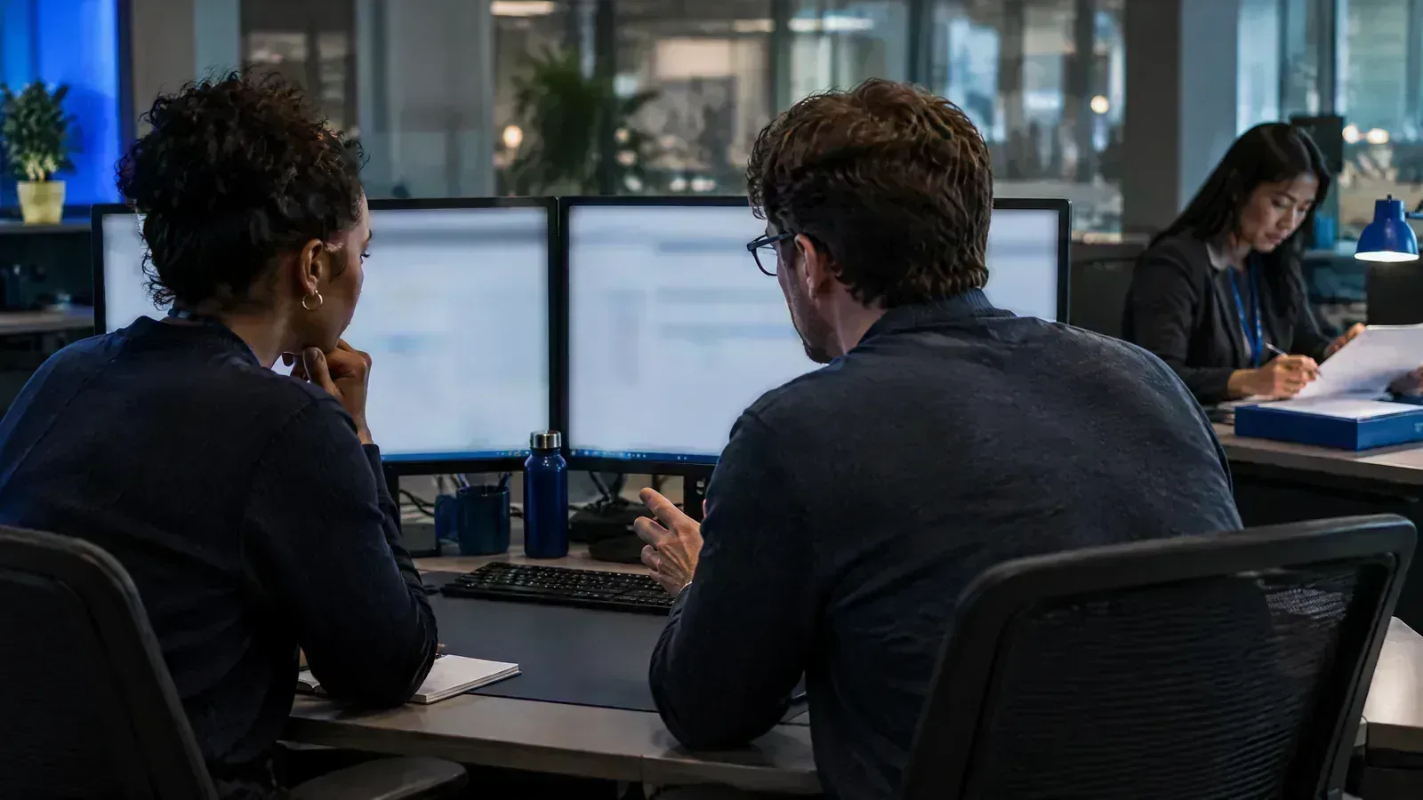 Fraud and customer-operations specialists review a disputed payment decision.